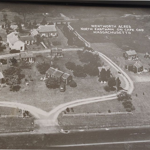 Aerial view of Wentworth Acres in North Eastham, Cape Cod, featuring several small cottages along a winding driveway.