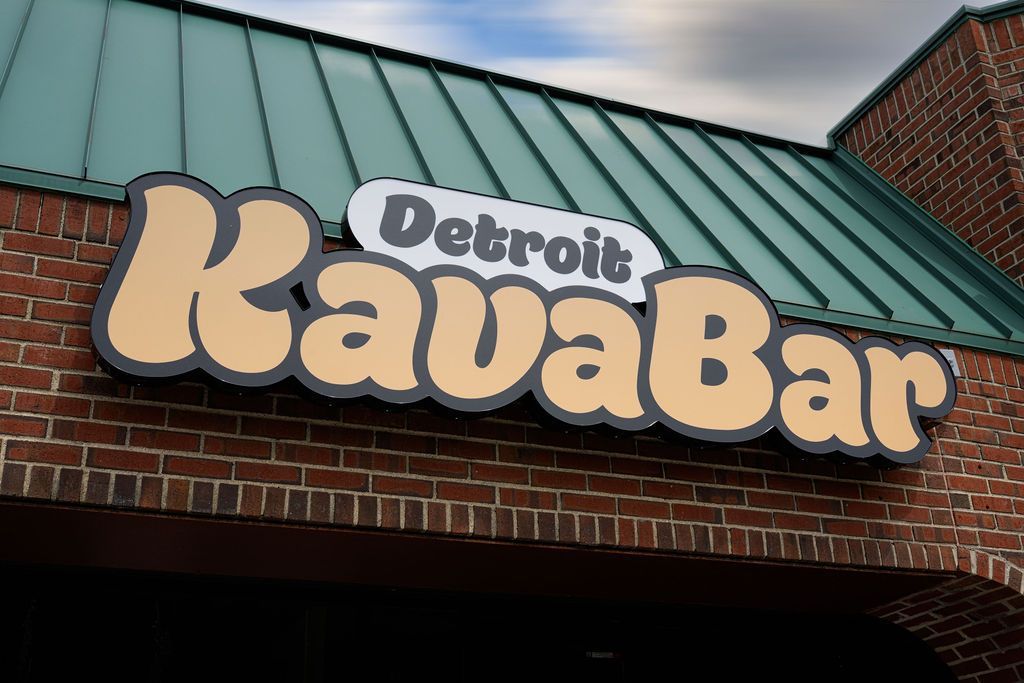 Detroit Kava Bar sign on a brick building with a green metal roof