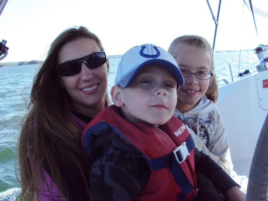 Woman and two children on a boat