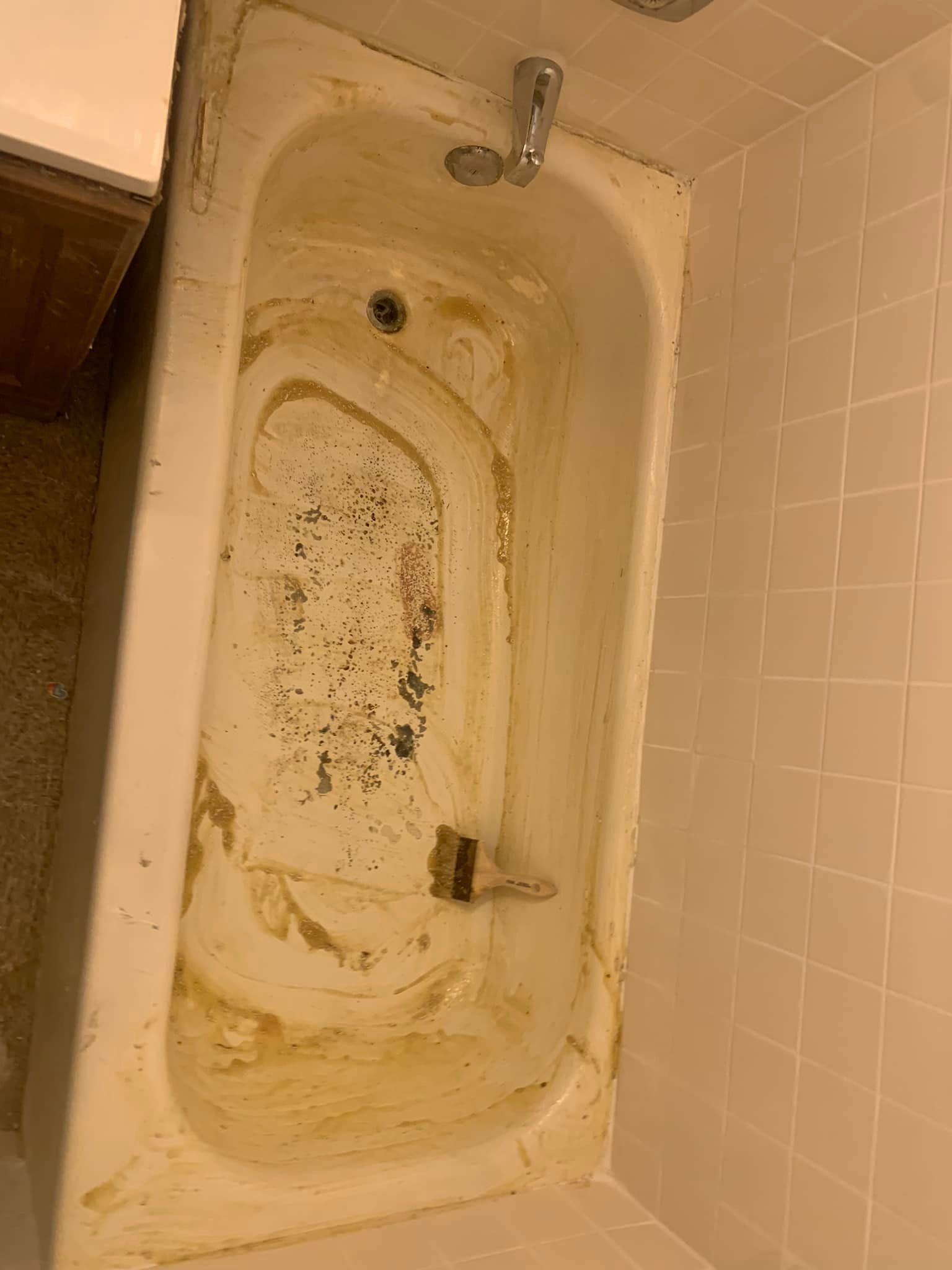 Image of a bathtub that is in the process of bathtub refinishing. It is getting scrubbed really good to remove any dirt. 