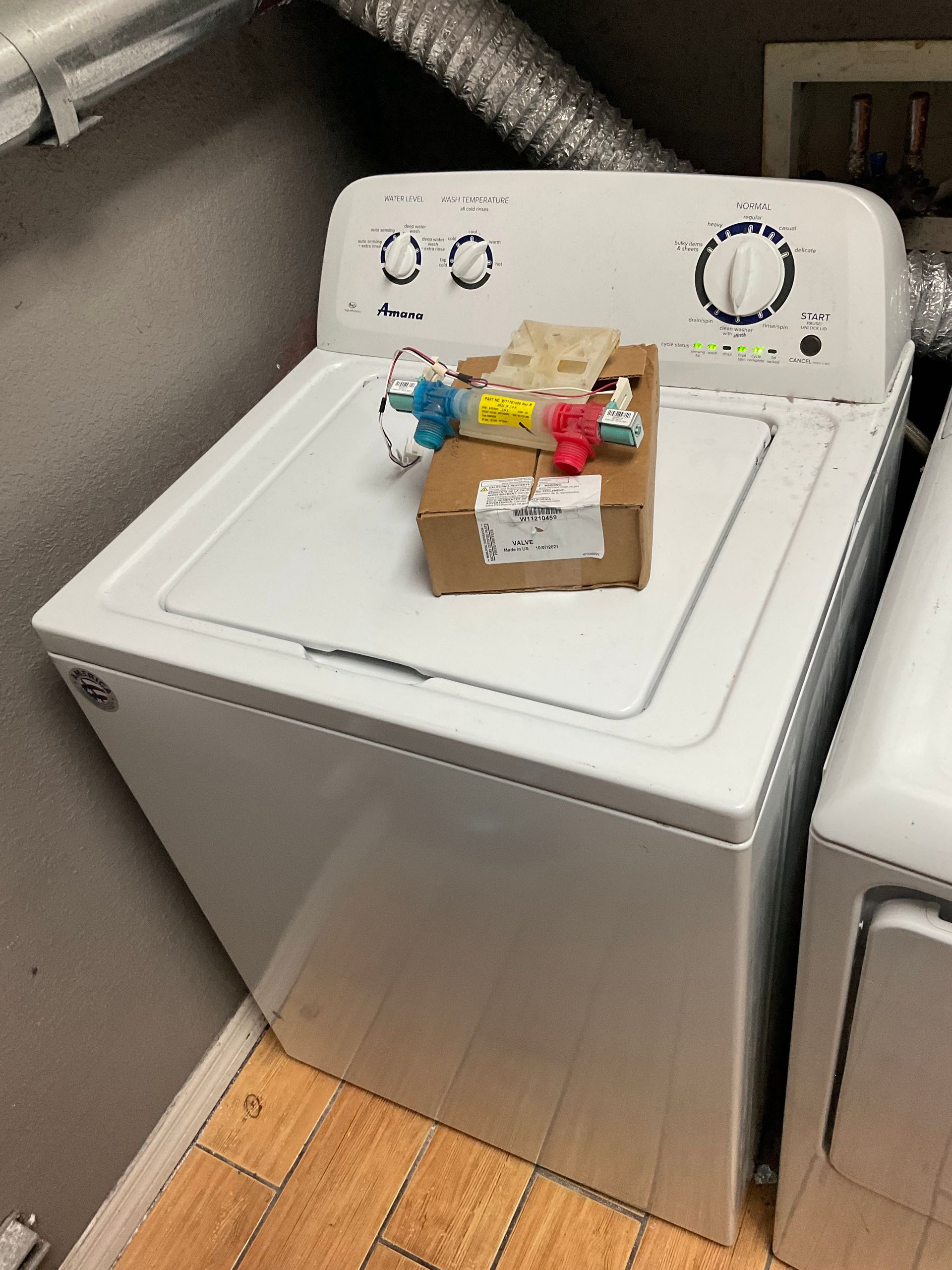 A white washer and dryer are in a laundry room.