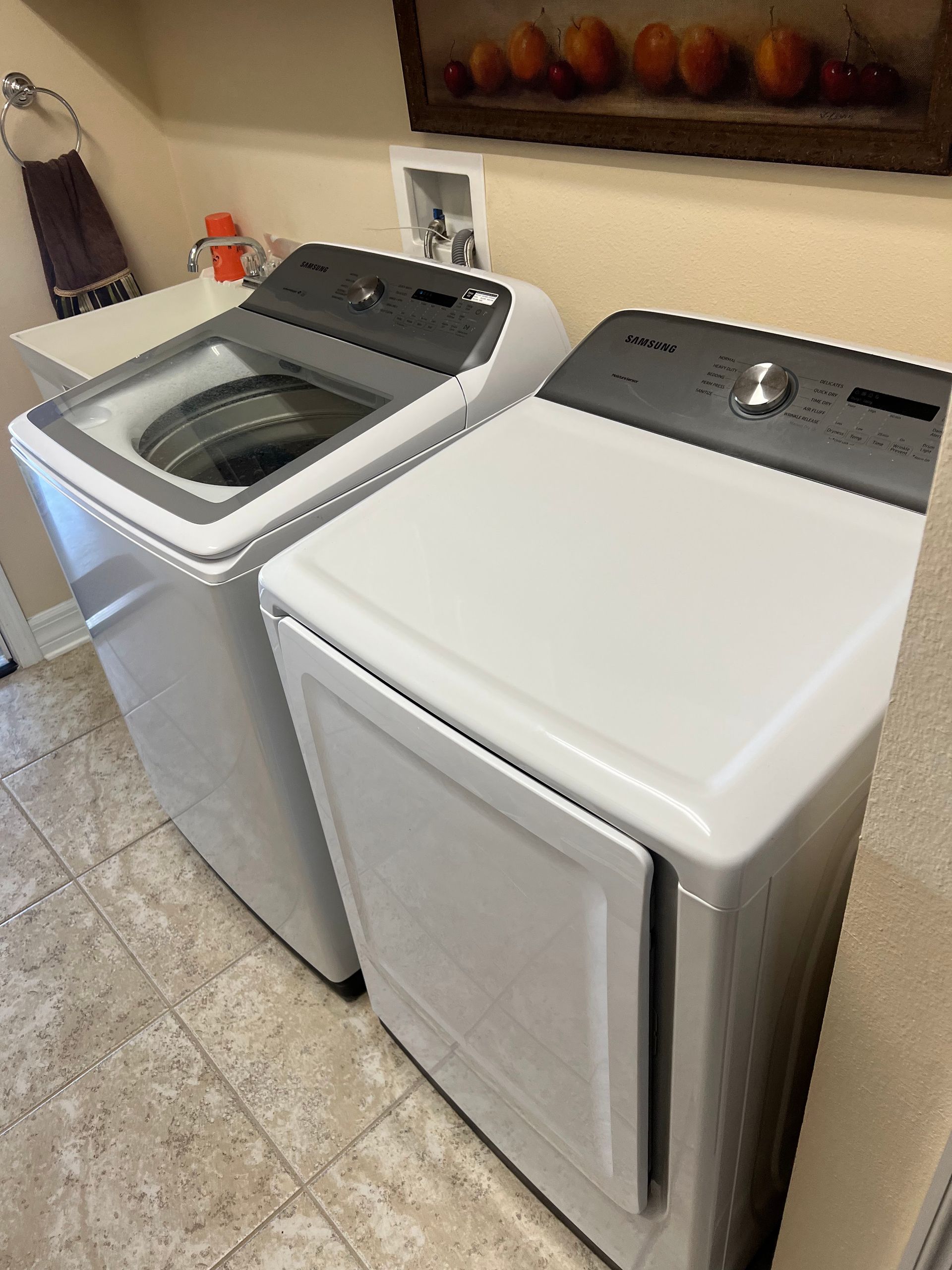 A washer and dryer are sitting next to each other in a laundry room.
