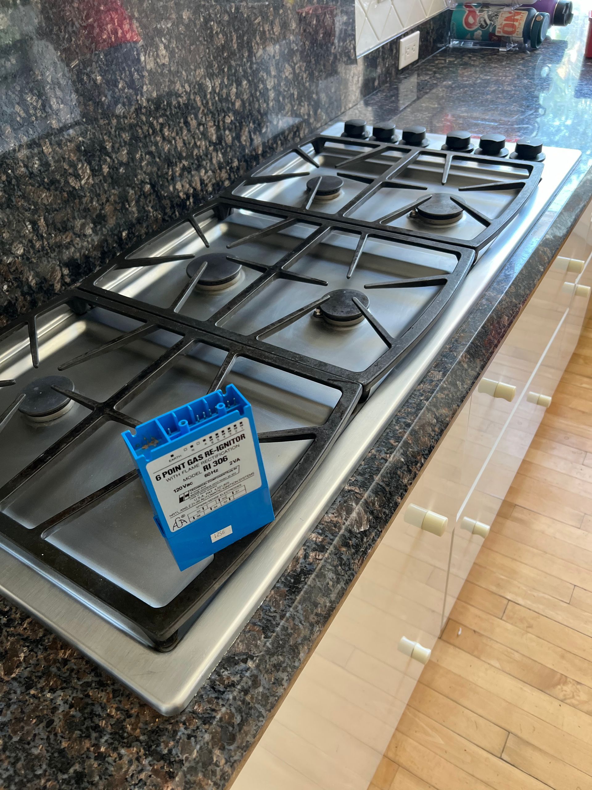 A stove top with a blue box on top of it