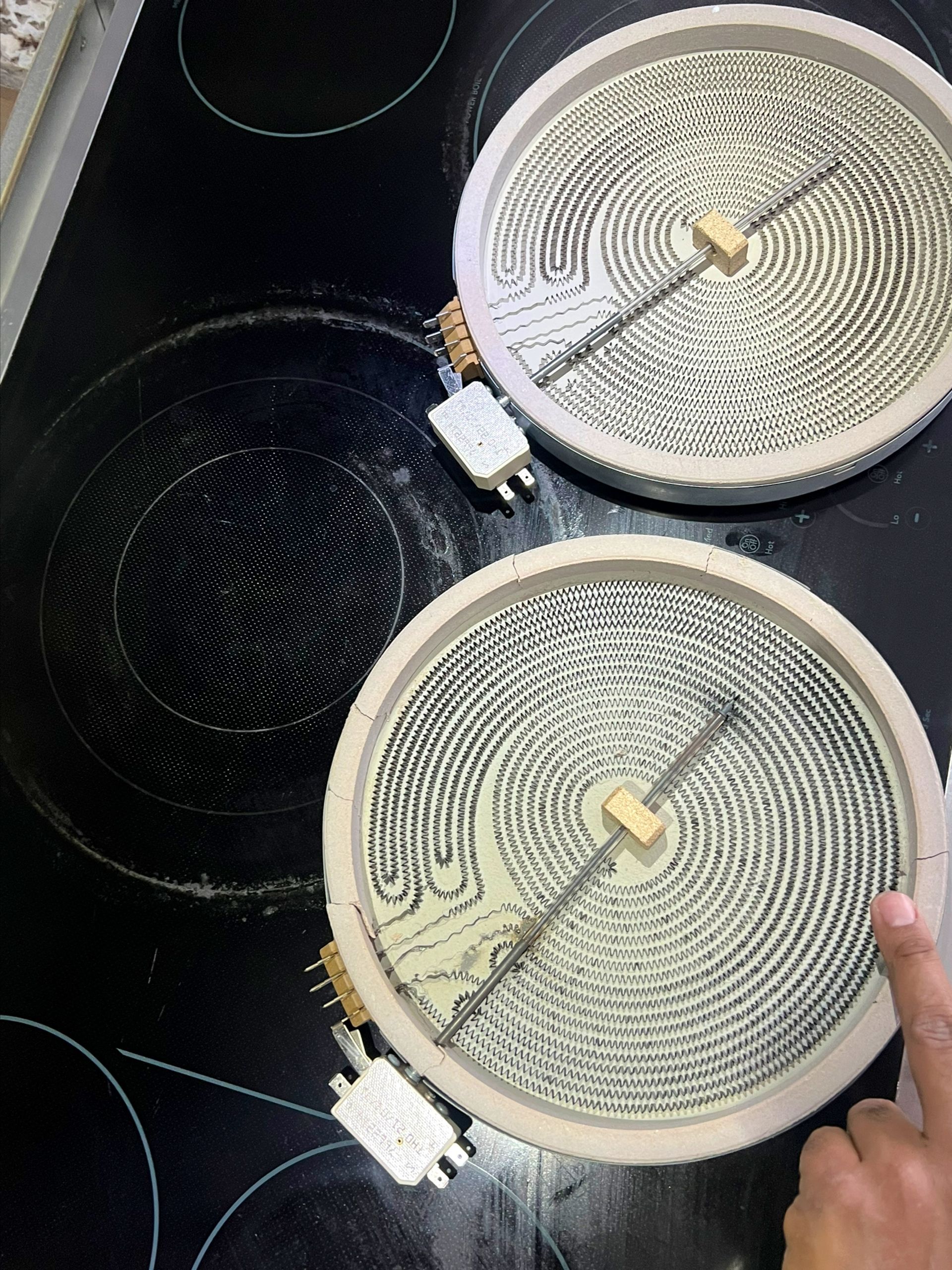 Two ceramic burners are sitting on top of a stove