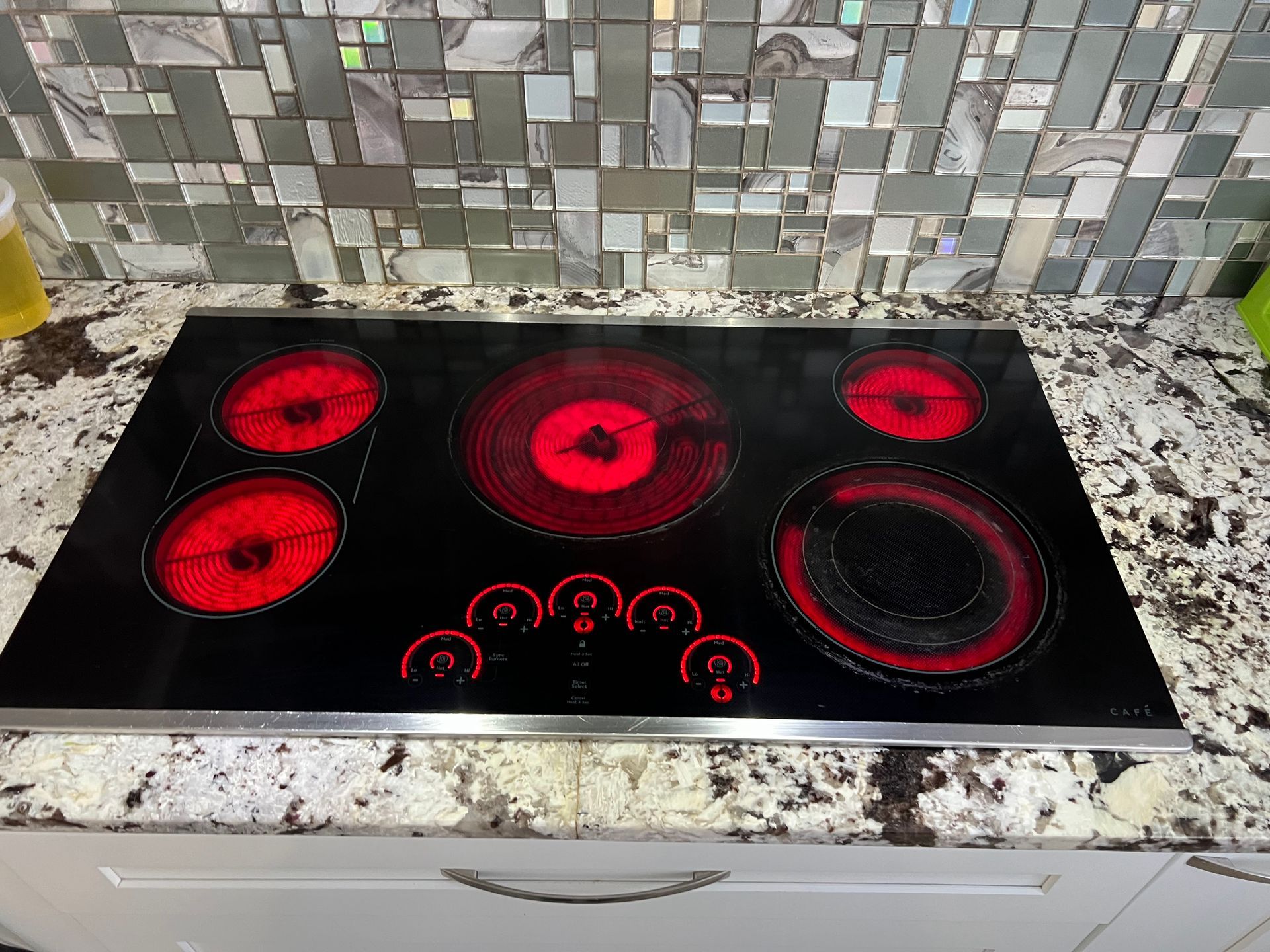 A stove top oven is sitting on top of a granite counter.