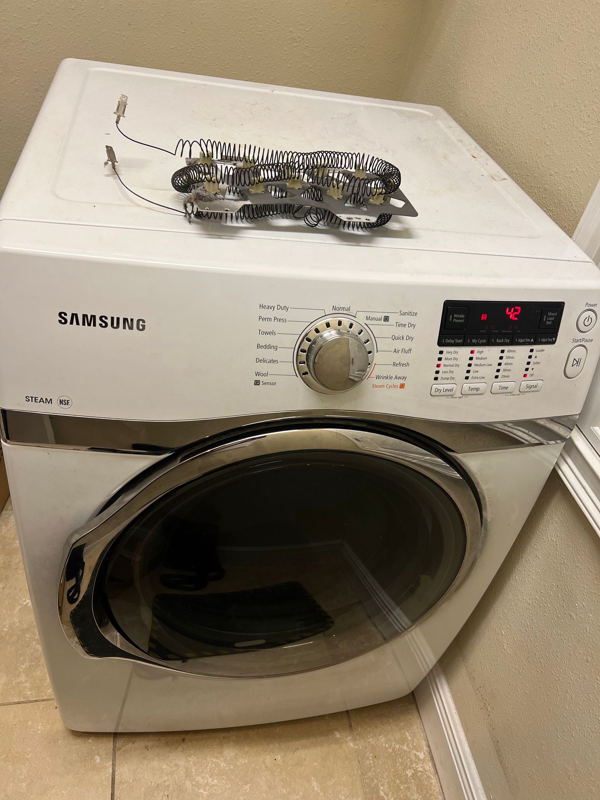 A white washing machine with a pair of sunglasses on top of it.