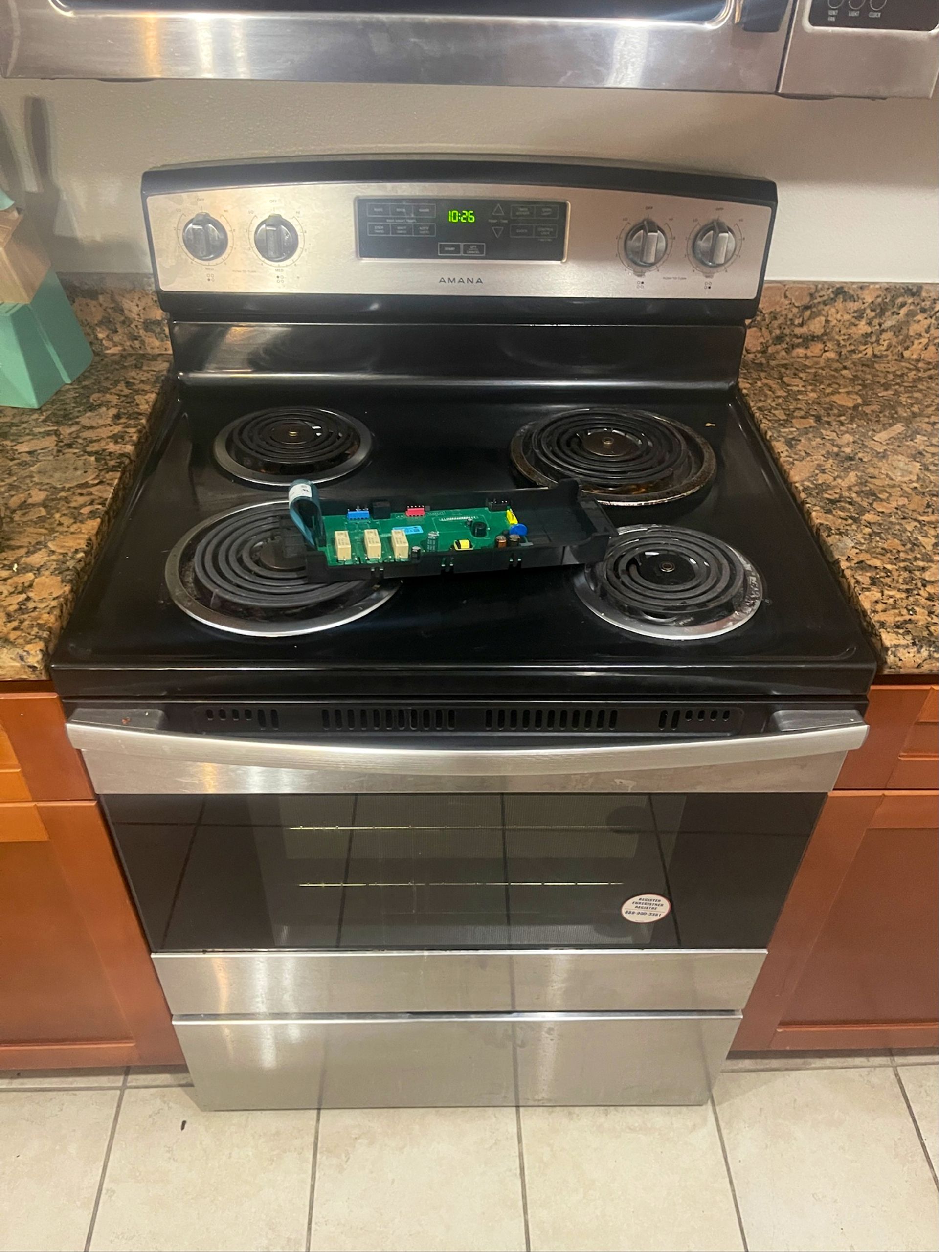 A black stove top oven is sitting on top of a granite counter.