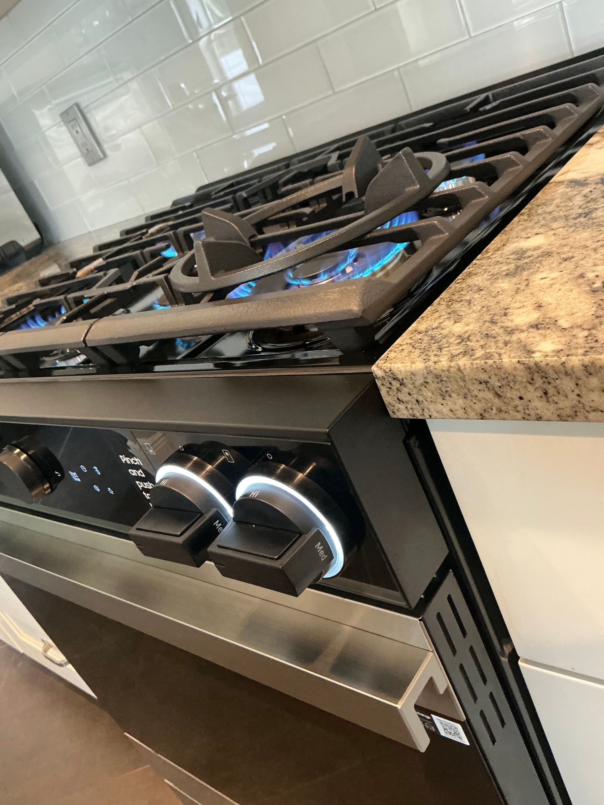 A stove top oven with a blue flame coming out of it