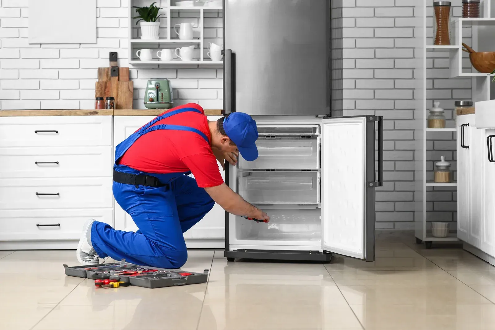 Stone outdoor pavilion with a dark wooden roof, built-in grill, and bench seating.