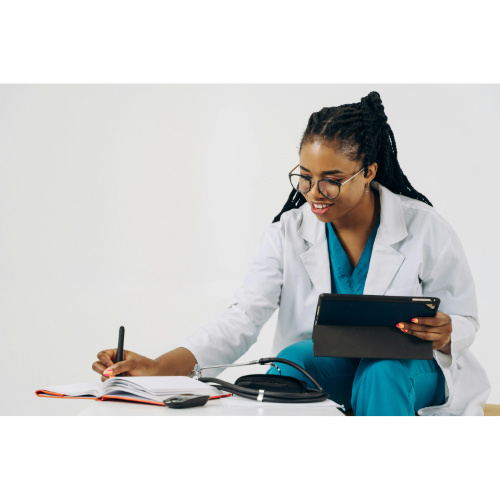 Medical professional writing notes while holding a tablet in a bright clinic setting