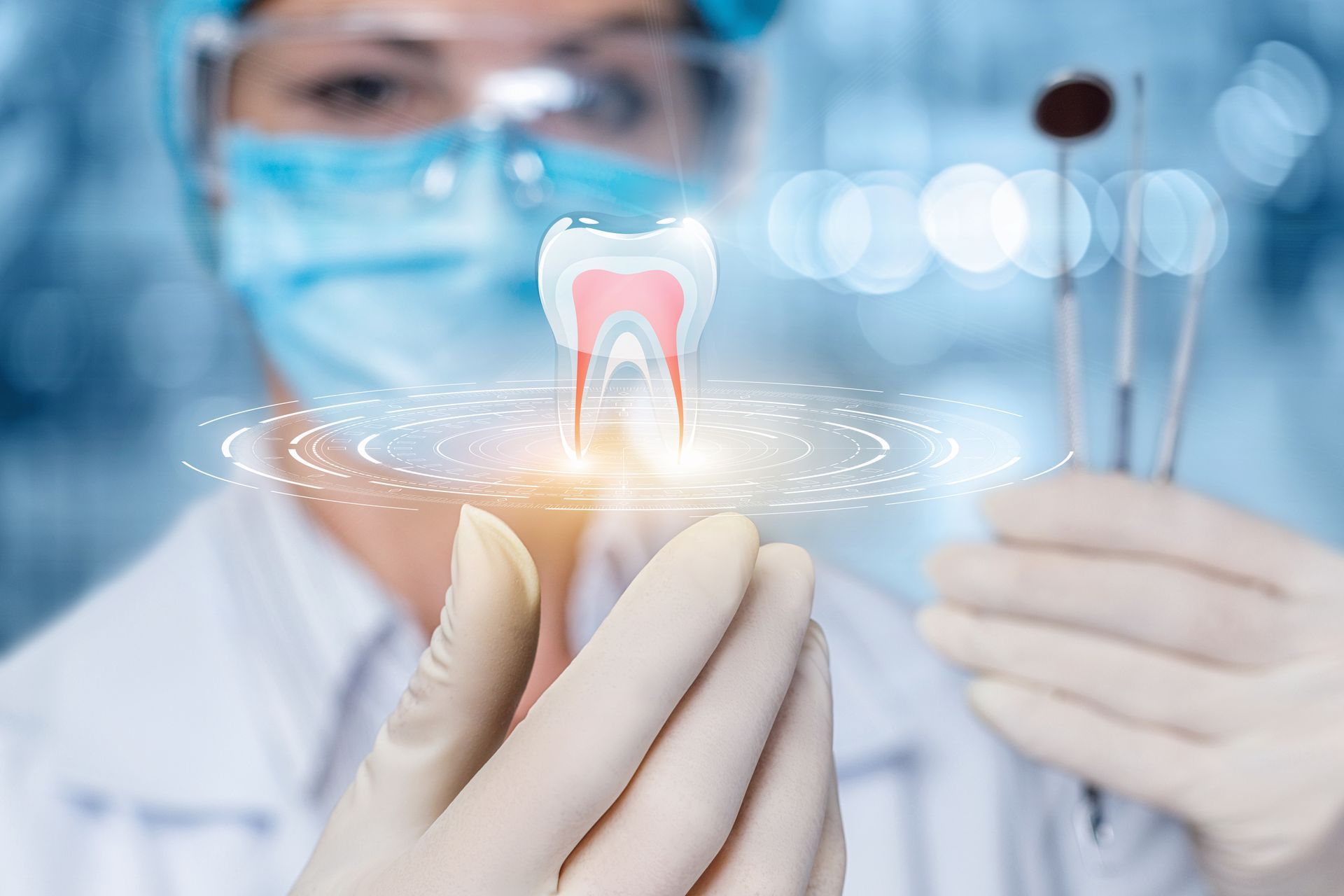 A dental professional in a mask and gloves holds a holographic projection of a tooth above their hands.