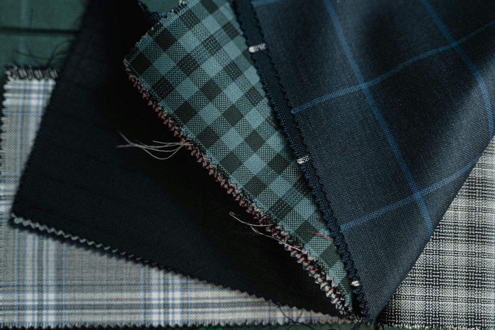 Diagonal rows of textured fabric swatches in white, navy, blue, gray, orange, red, and beige