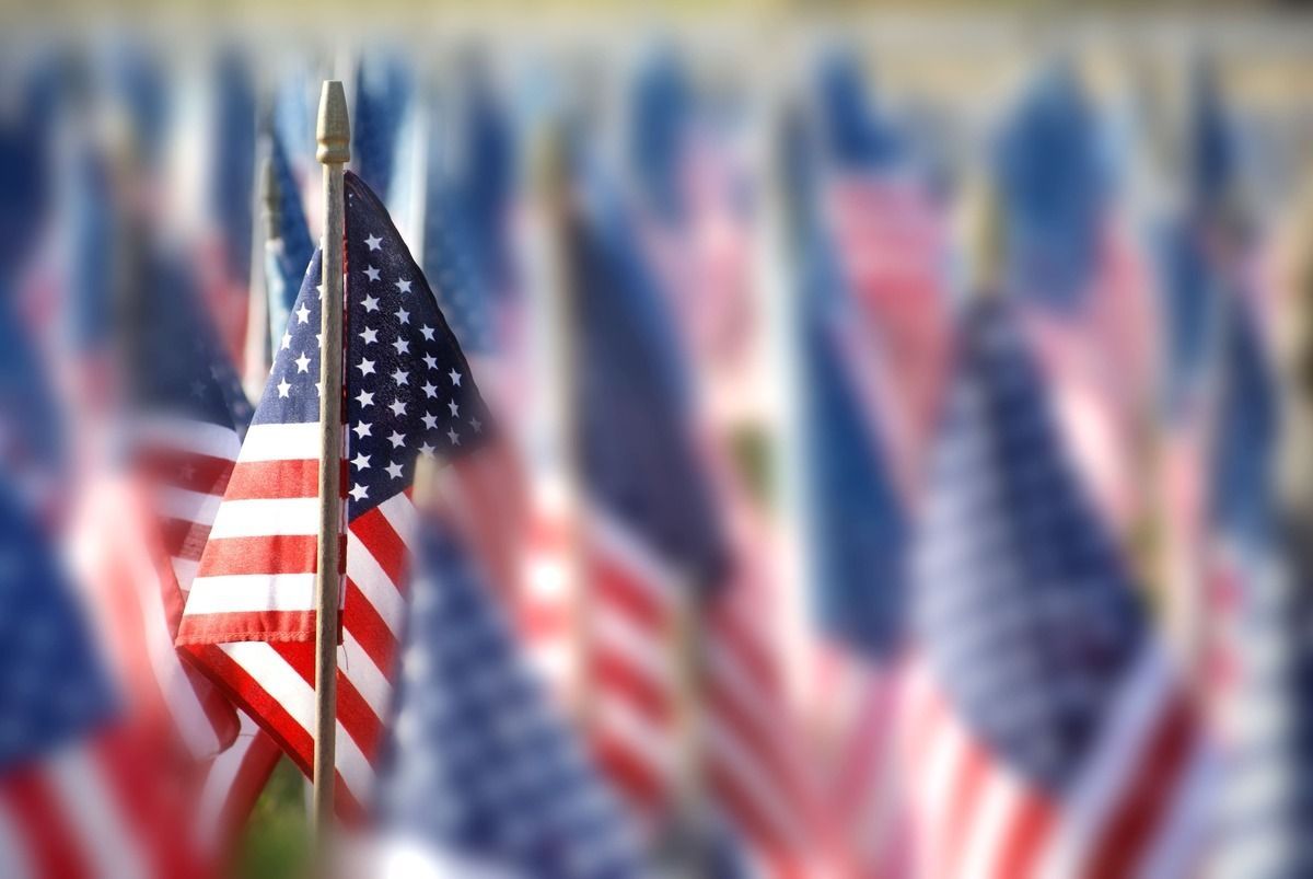 Blurred American flags waving in a patriotic outdoor scene