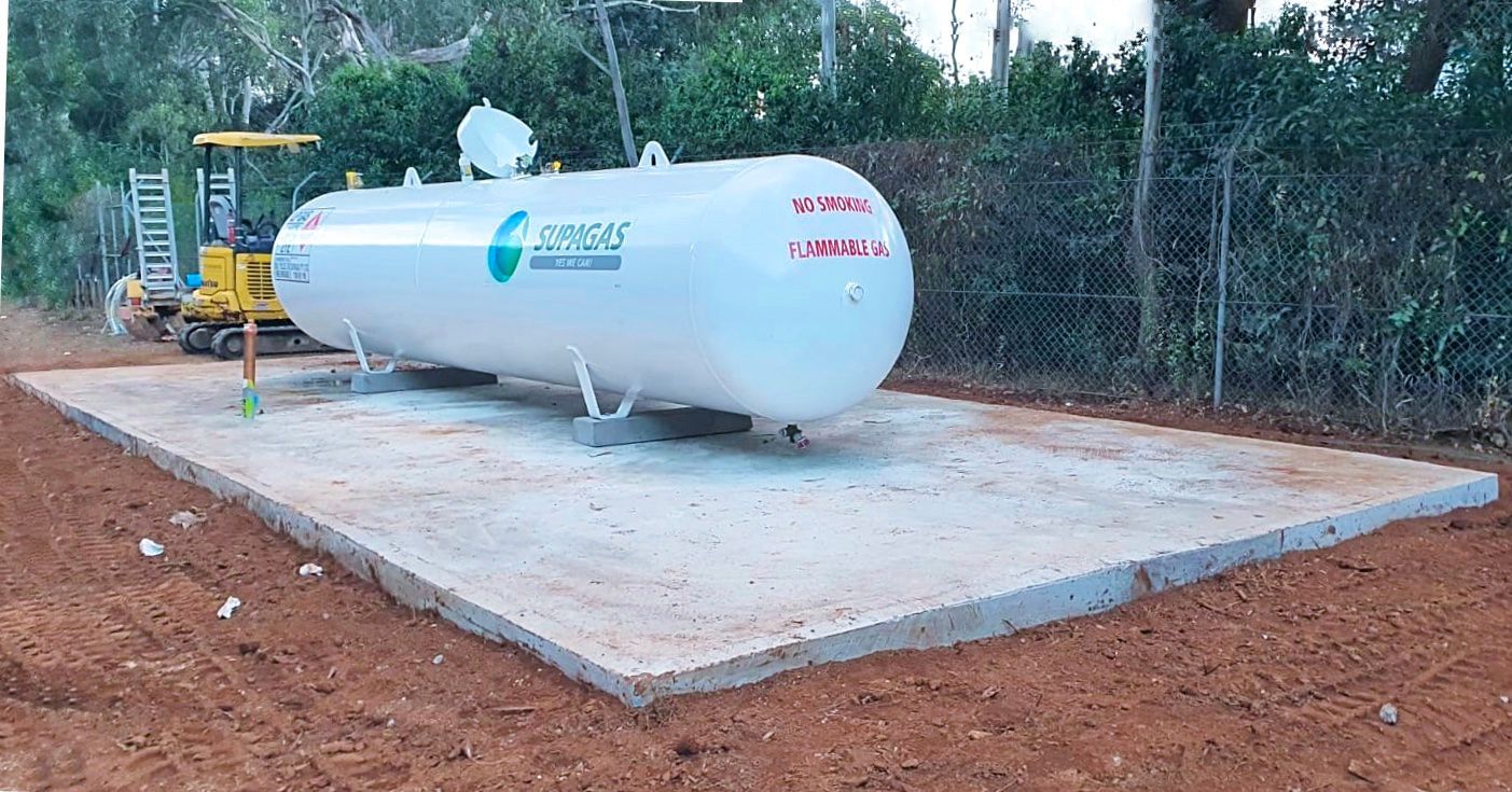 A Large Propane Tank is Sitting on Top of a Concrete Platform — Accurate Fitout Solutions In Wetherill Park, NSW