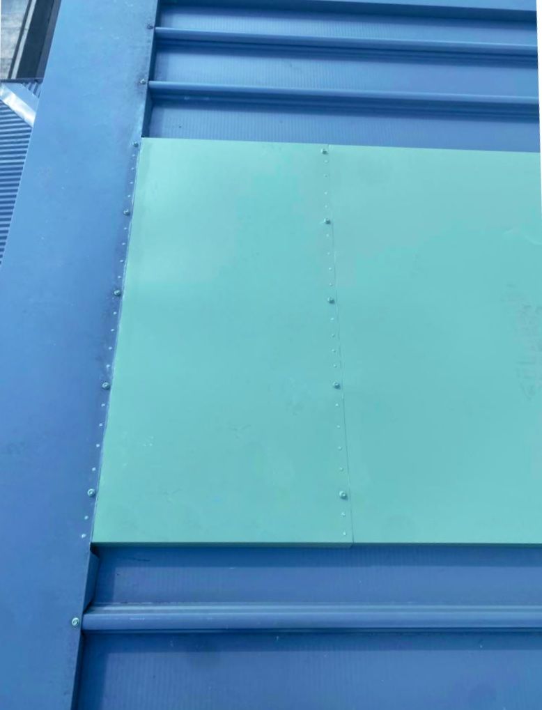A Blue Roof With a Green Sheet of Paper on It — Accurate Fitout Solutions In Wetherill Park, NSW