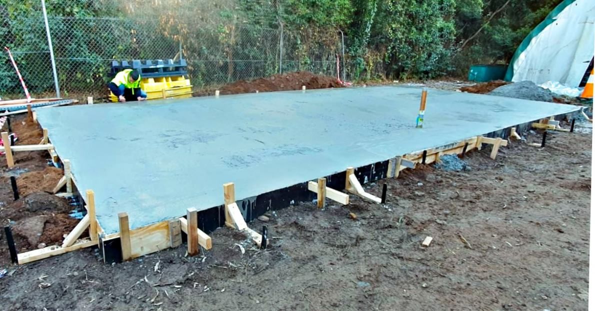 A Large Concrete Slab is Sitting on Top of a Dirt Field — Accurate Fitout Solutions In Wetherill Park, NSW