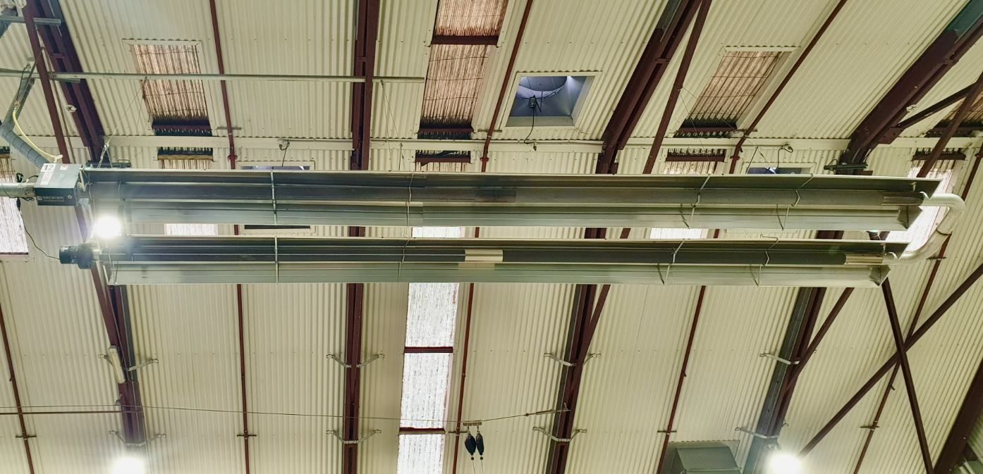 A Large Heater is Hanging From the Ceiling of a Building — Accurate Fitout Solutions In Wetherill Park, NSW