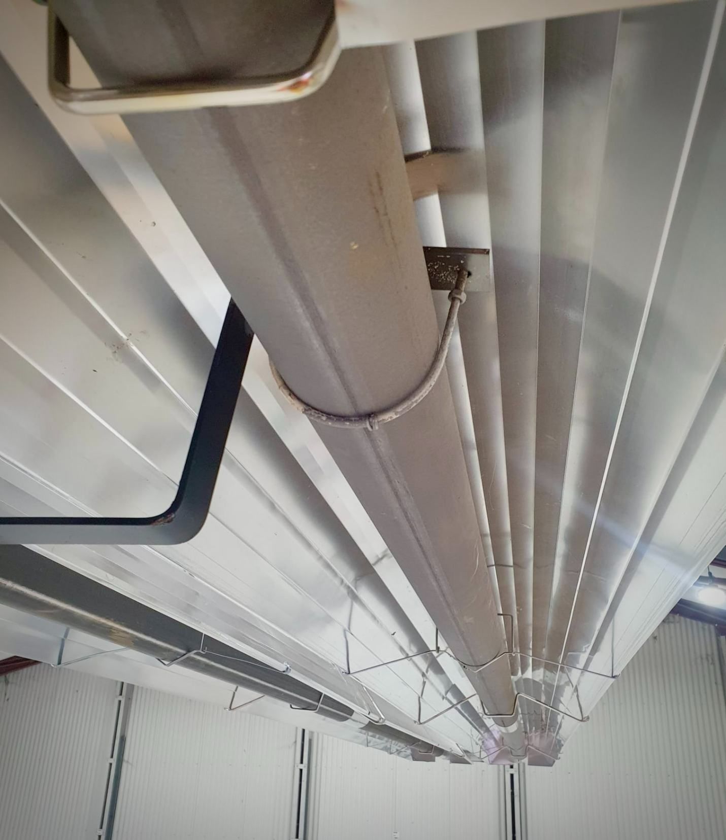 A Bunch of Pipes Hanging From the Ceiling of a Building — Accurate Fitout Solutions In Wetherill Park, NSW