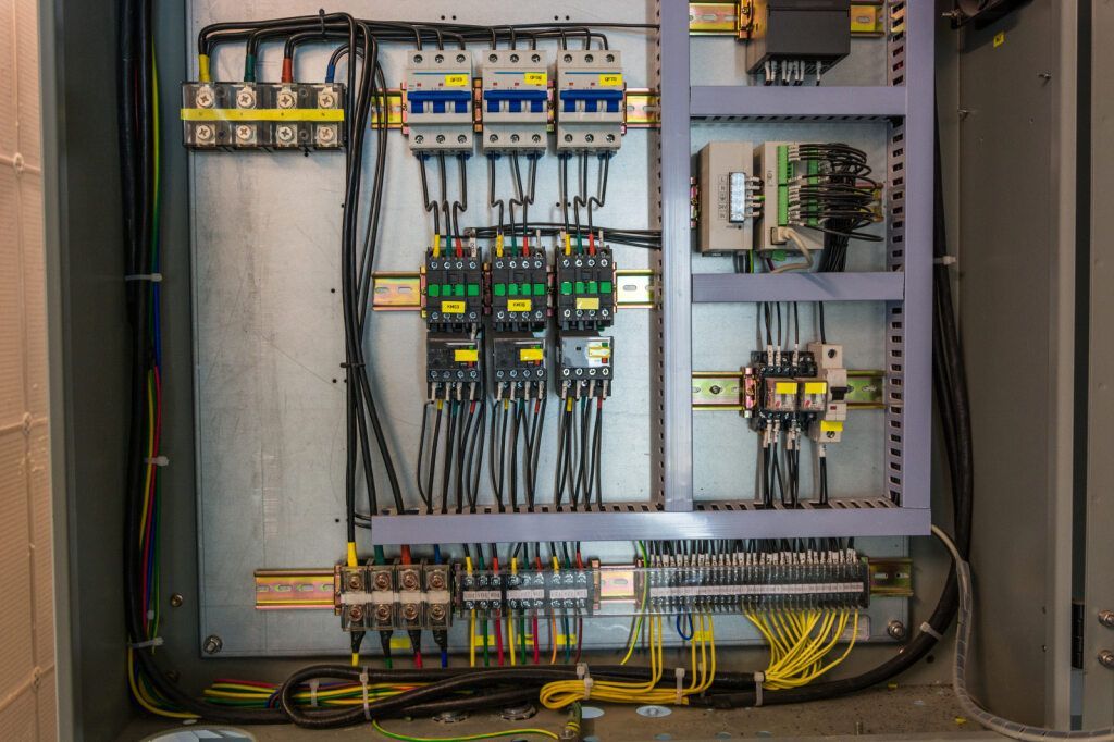An Electrical Control Panel With a Lot of Wires Coming Out of It — Accurate Fitout Solutions In Wetherill Park, NSW