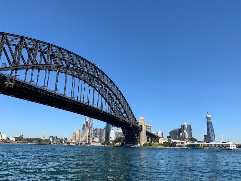 A Bridge Over a Body of Water With a City in the Background — Accurate Fitout Solutions In Sydney, NSW
