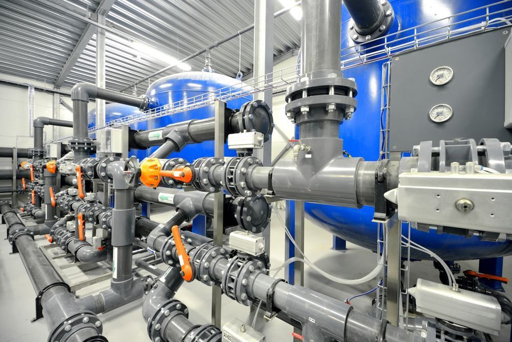 A Warehouse Filled With Lots of Pipes and Valves — Accurate Fitout Solutions In Prestons, NSW