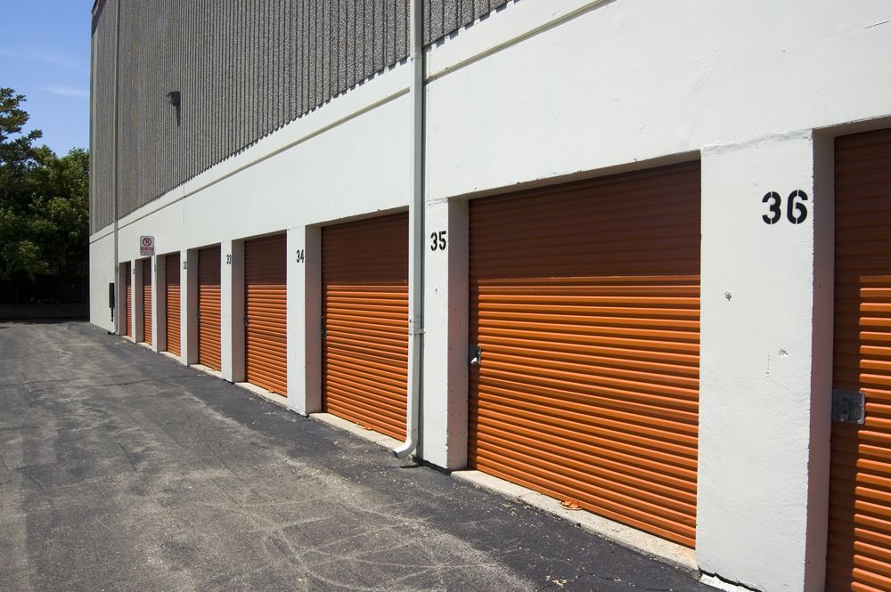 A Row of Orange Garage Doors — Accurate Fitout Solutions In Wetherill Park, NSW