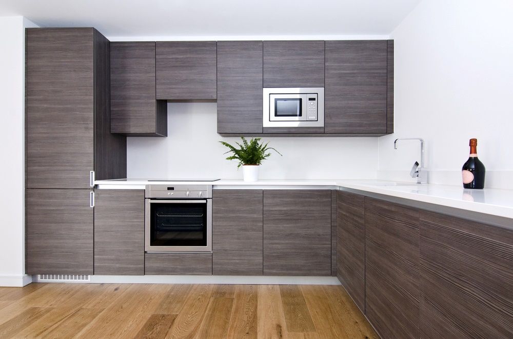 A Kitchen With Wooden Cabinets — The Right Kitchen Company in Thirroul, NSW