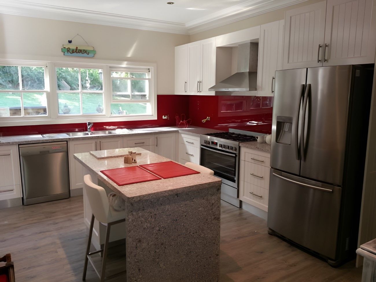 A Kitchen With Stainless Steel Appliances And A Large Island — The Right Kitchen Company In Berkley, NSW