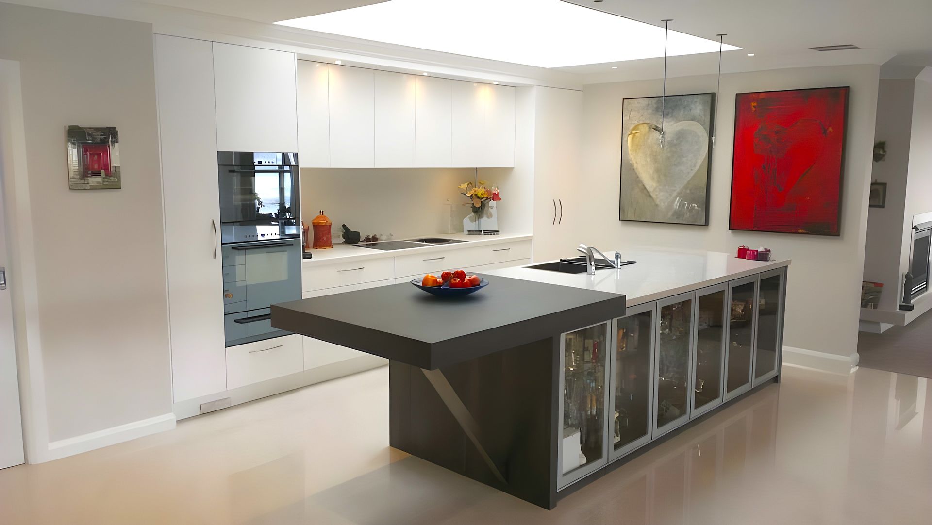 A light kitchen with dark extended bench top — The Right Kitchen Company In Berkeley, NSW
