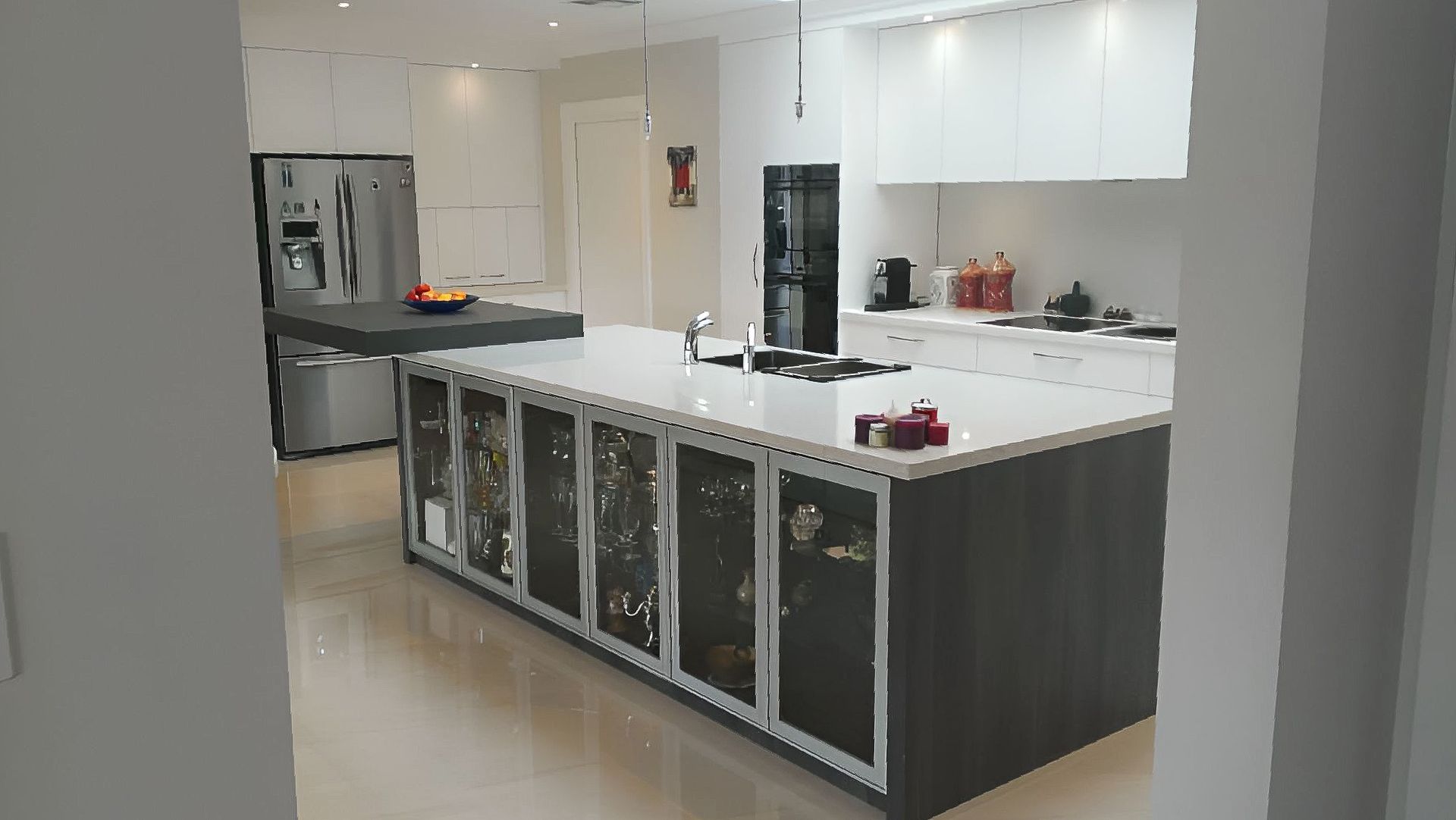 A Kitchen With A Large Island, Sink And Refrigerator — The Right Kitchen Company in Albion Park, NSW