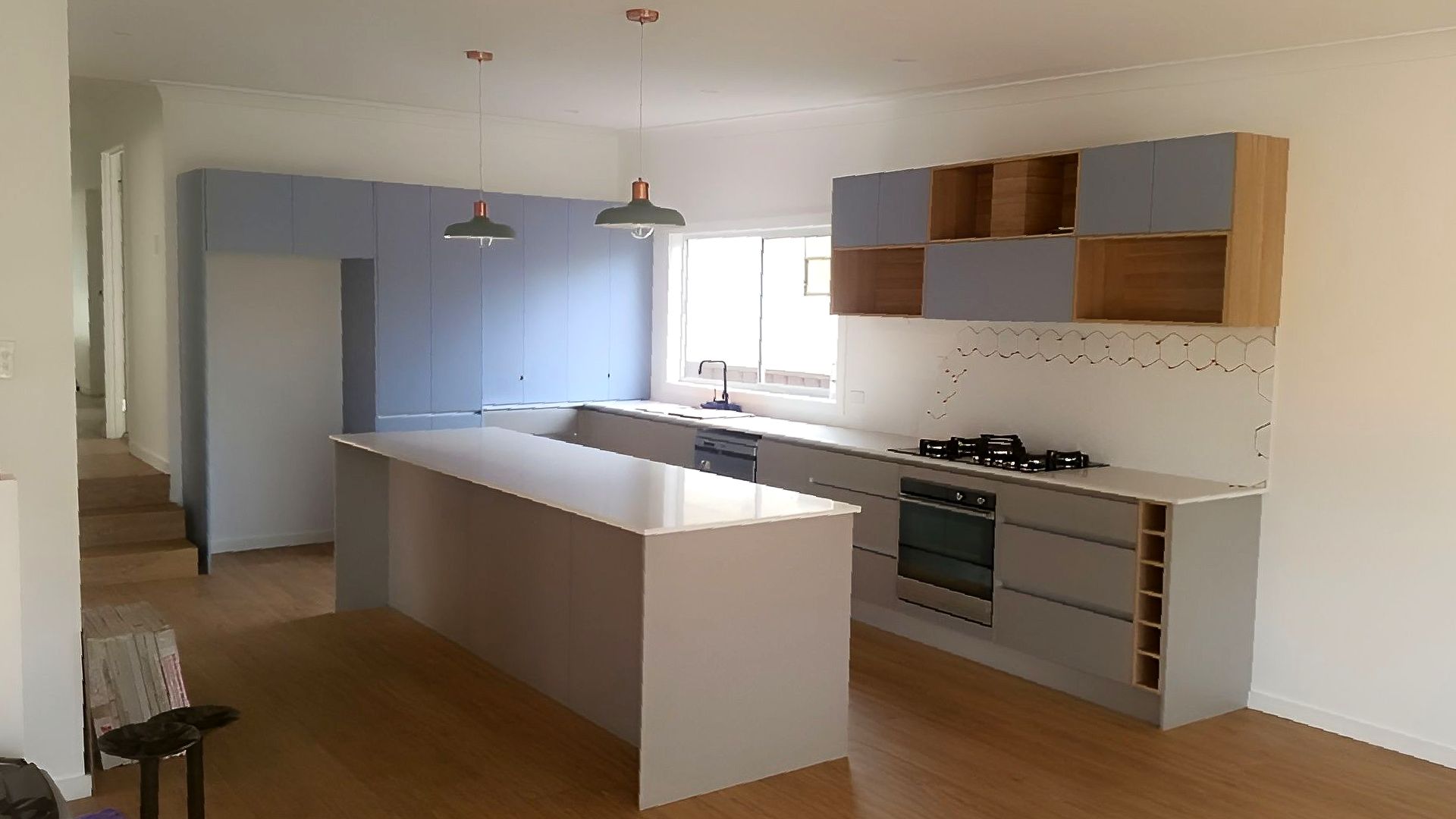 A Laundry Room With A Washing Machine And Cabinets — The Right Kitchen Company In Berkeley, NSW