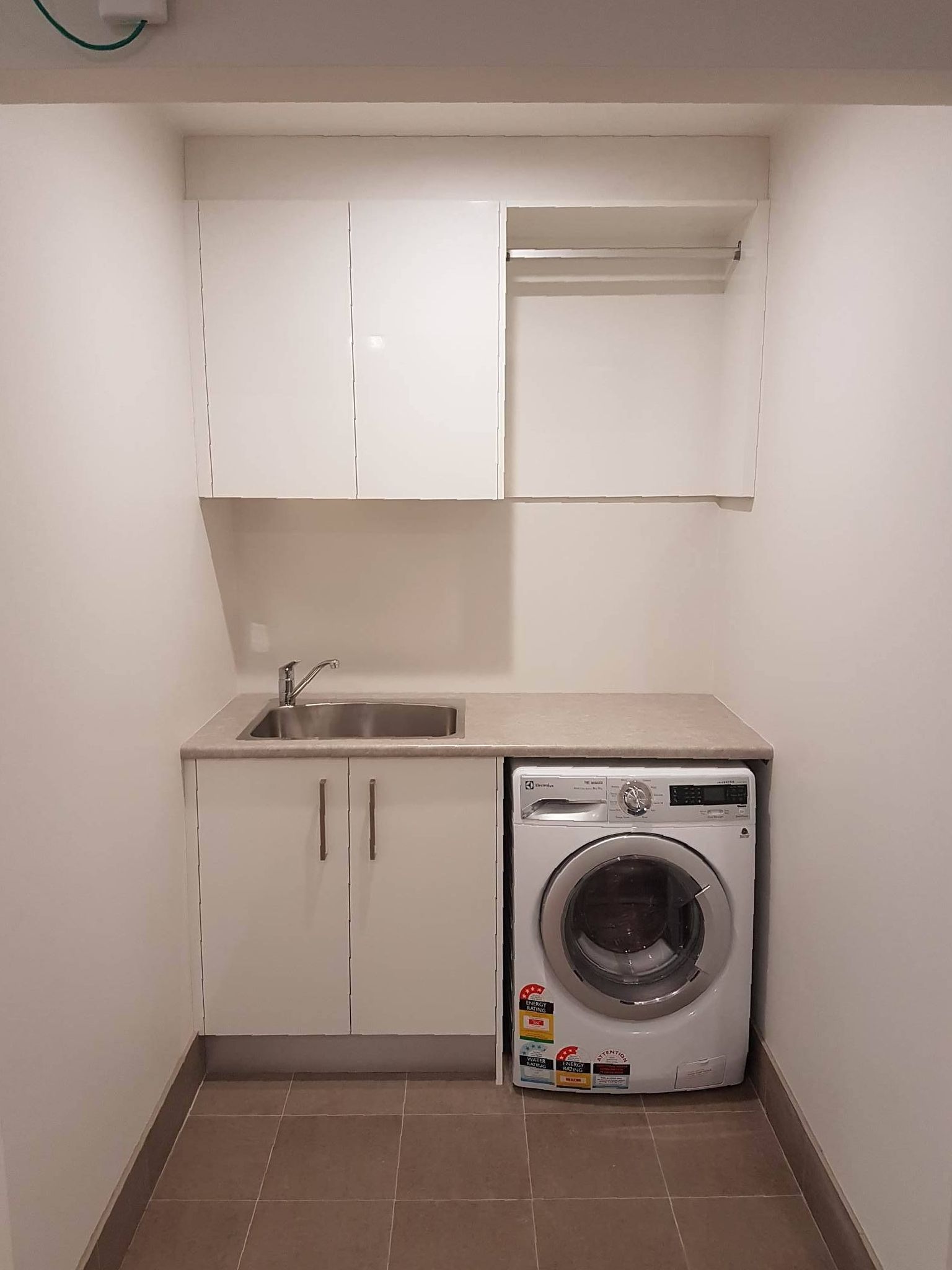 Laundry with tidy cabinets — The Right Kitchen Company in Dapto, NSW