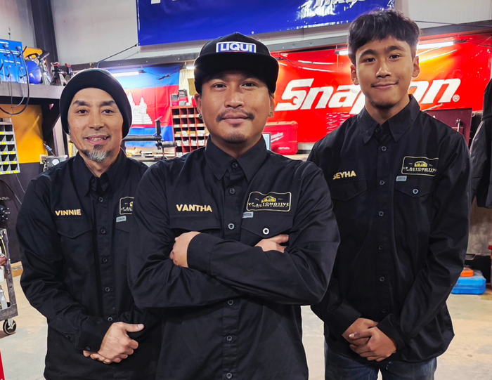 Three Staff Members In Black Uniforms Standing In Front Of A Red Snap-on Sign Inside A Shop | VP Automotive LLC