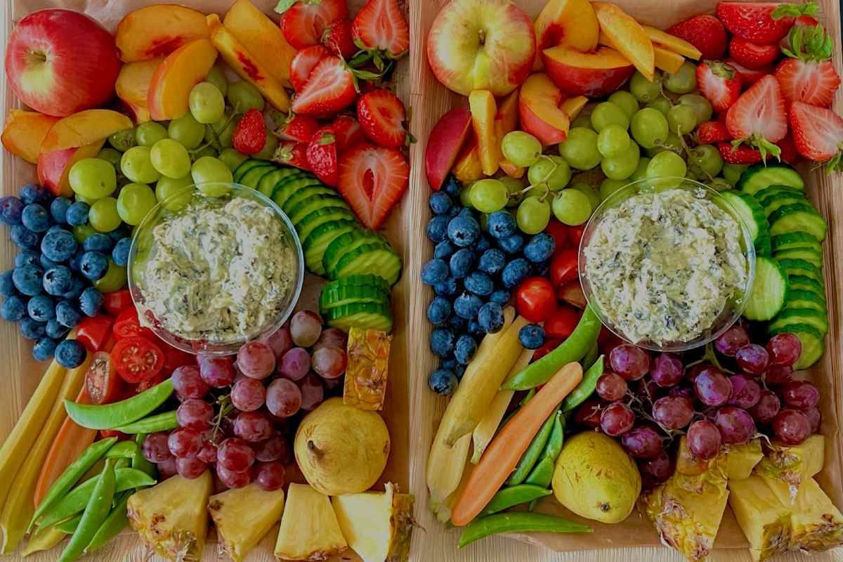 A wooden tray filled with fruits and vegetables.