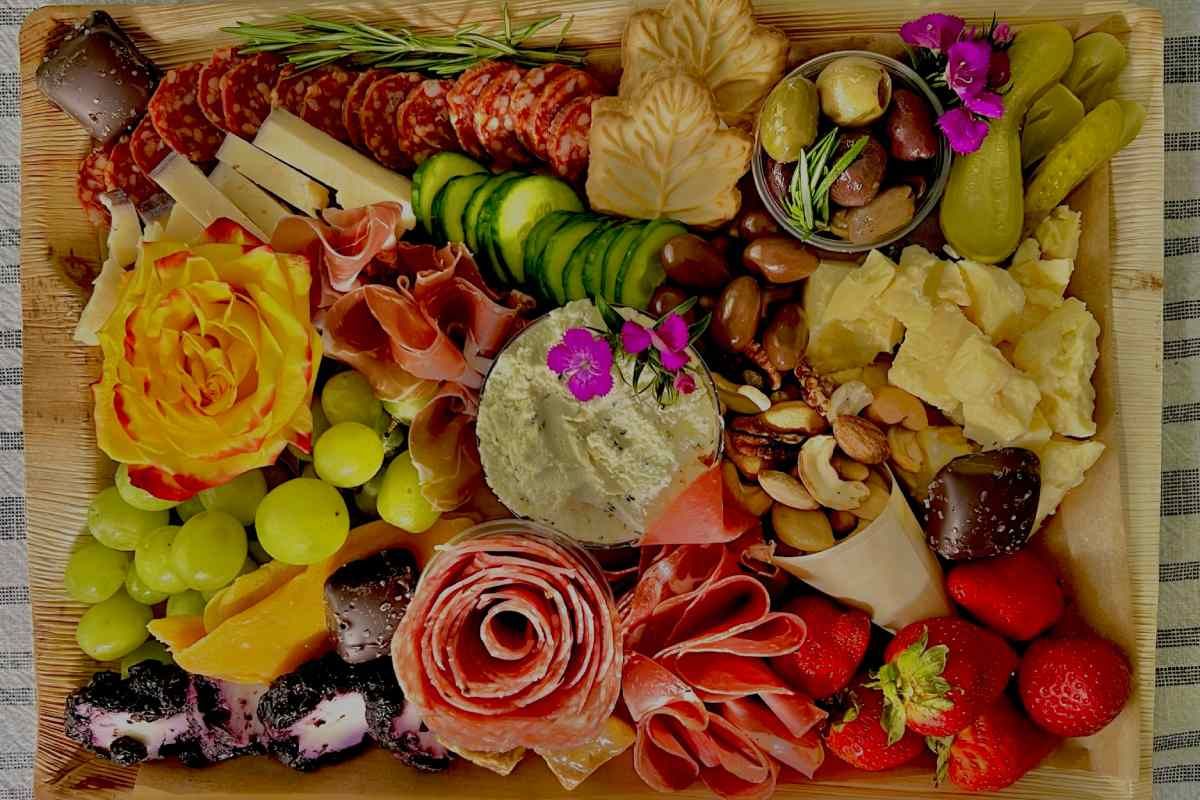 A wooden cutting board filled with lots of different types of food.