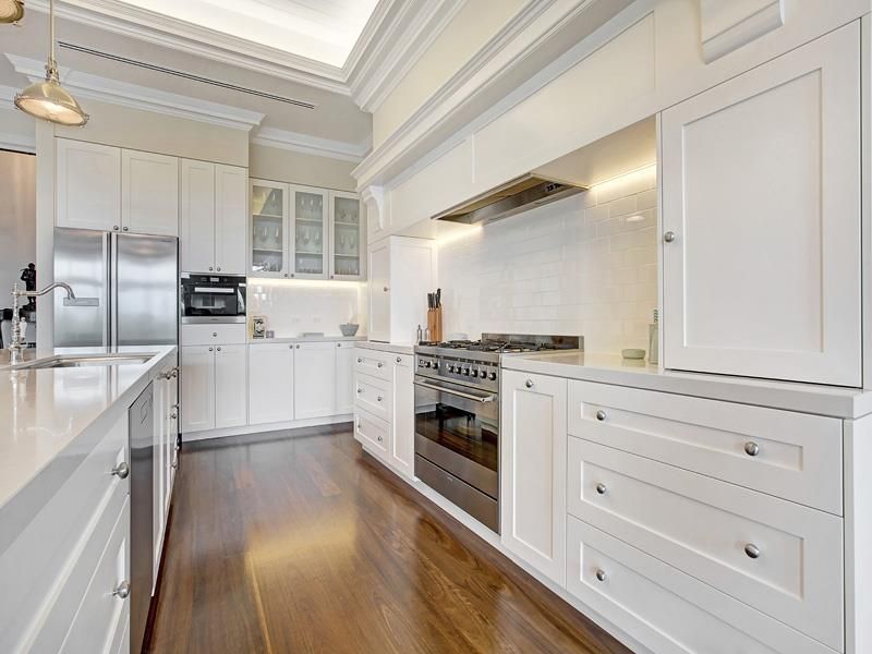 A interior of a small truffle taupe coloured shaker style fitted kitchen