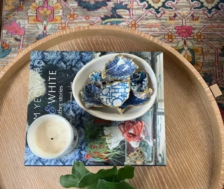 A wooden tray with a book and a bowl on top of it