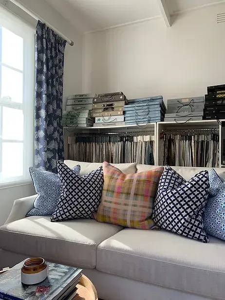 A living room with a couch and lots of pillows