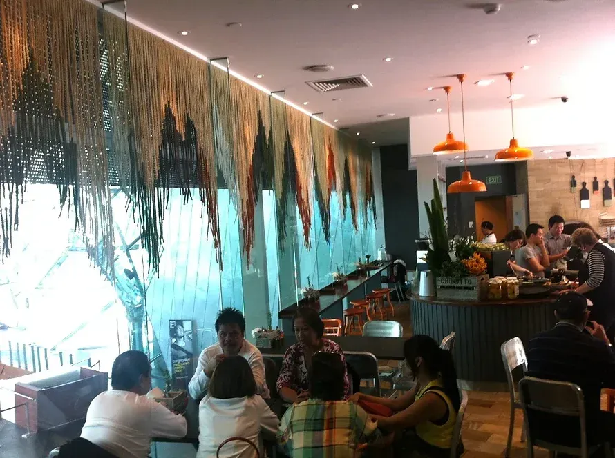 A group of people are sitting at tables in a restaurant