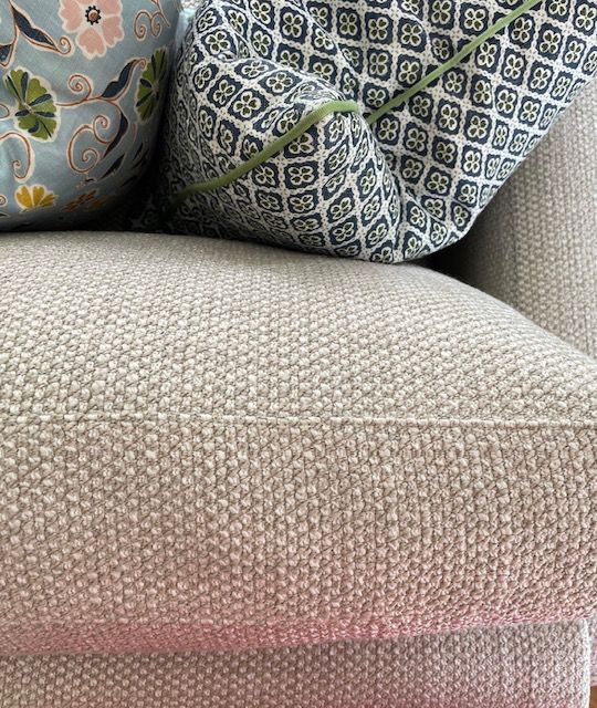 A close up of a couch with two pillows on it.