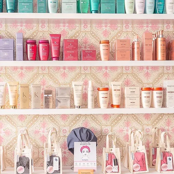 A shelf filled with lots of different types of beauty products