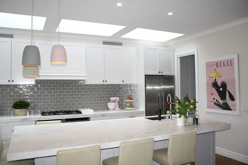 A kitchen with white cabinets and stainless steel appliances