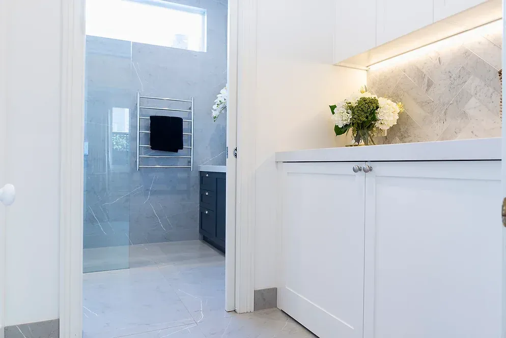 A bathroom with a walk in shower and a sink.