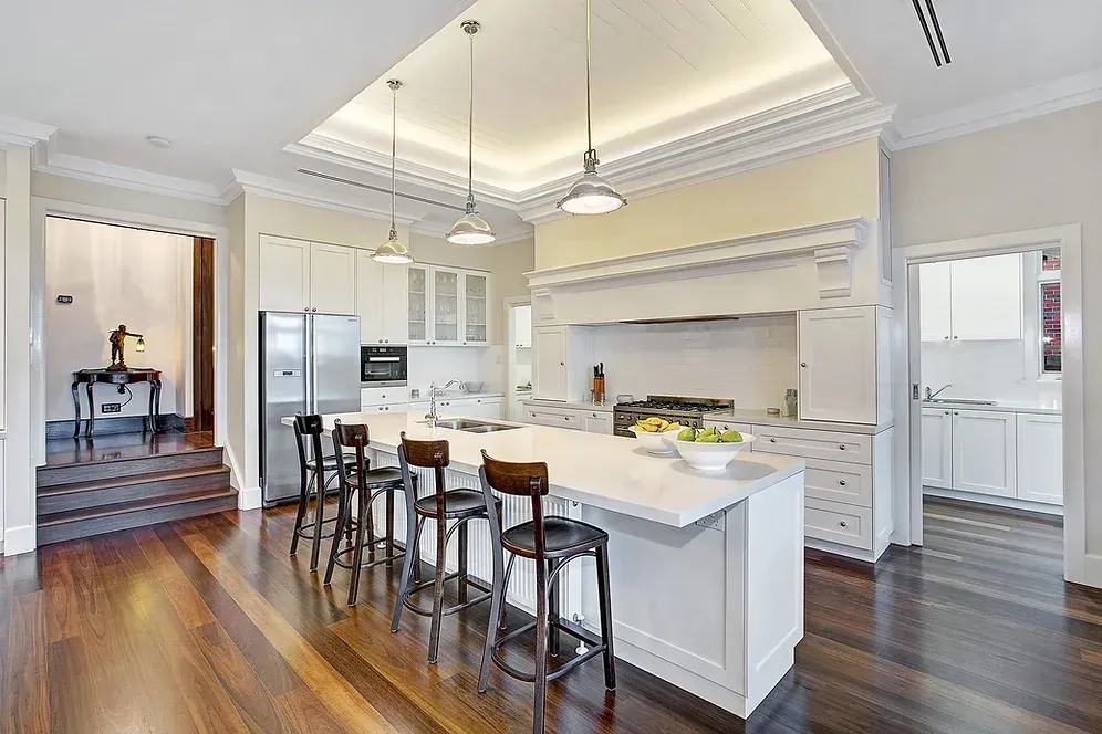 A large kitchen with a large island and stools
