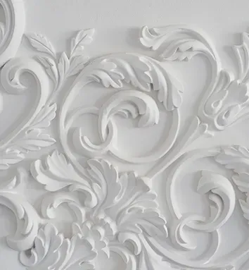 A close up of a white carving on a wall.
