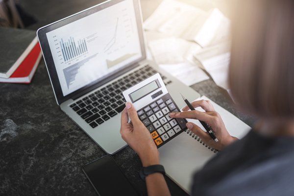 Woman Doing Financial Computations — Monroe, LA — Woodard & Associates APAC Woman Doing Financial Computations — Monroe, LA — Woodard & Associates APAC