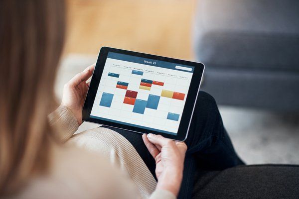 Woman Looking to Online Tax Calendar — Monroe, LA — Woodard & Associates APAC Woman Looking to Online Tax Calendar — Monroe, LA — Woodard & Associates APAC