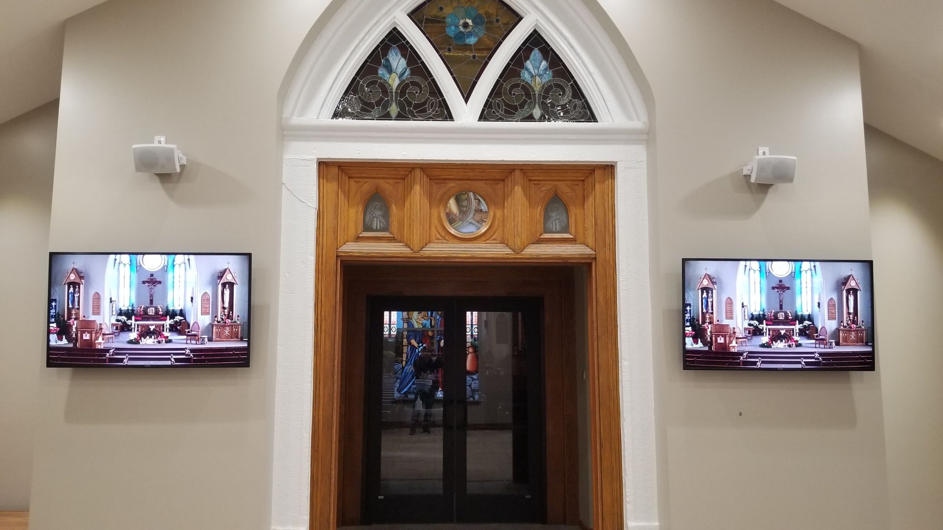 Two TVs and speakers installed by fisher custom av display church mass in norwalk ohio