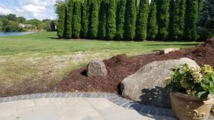 An outdoor rock speaker and landscape speakers with an outdoor audio system.