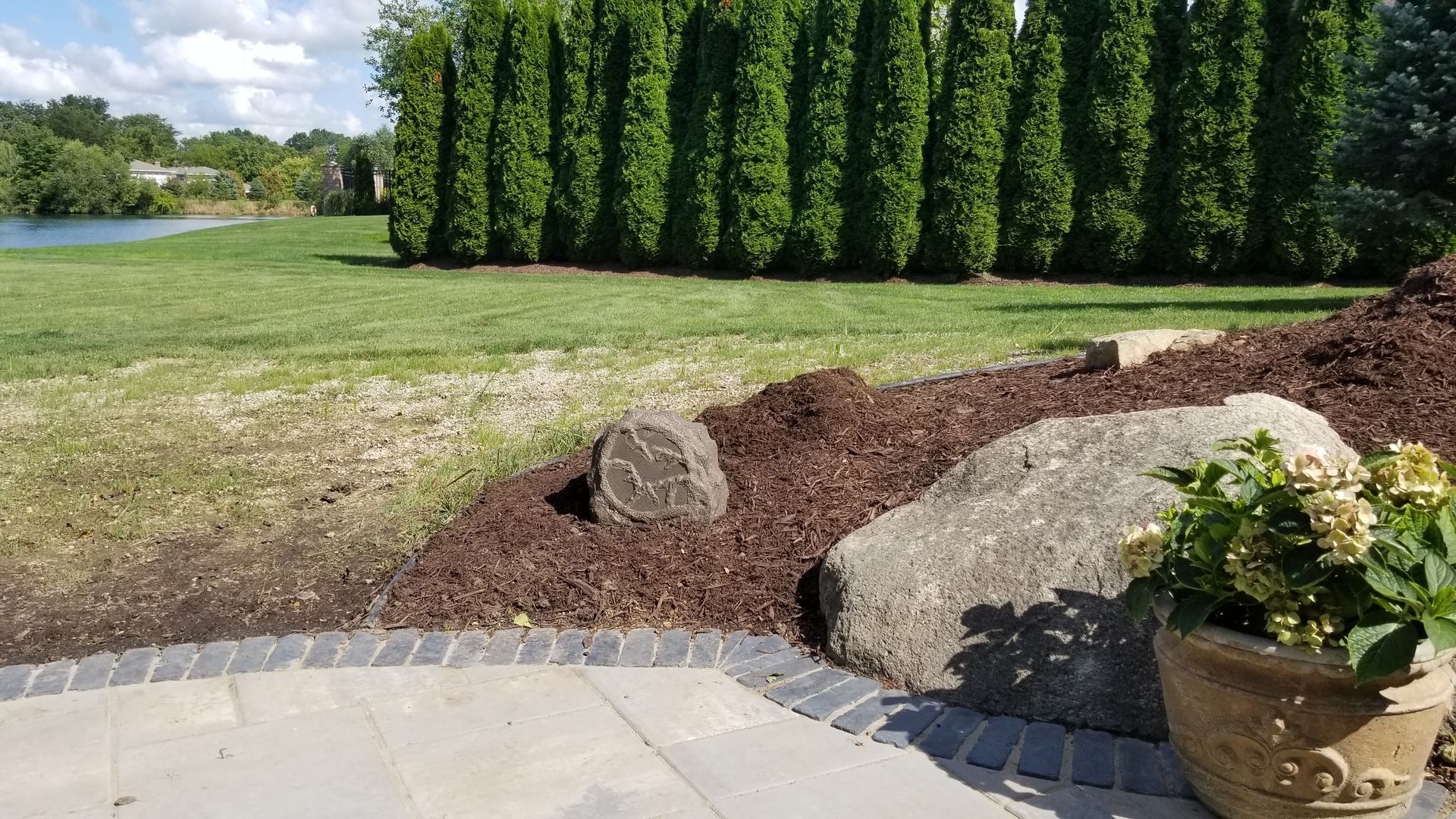 Landscape rock speaker installed by fisher custom av for an outdoor audio system in Sandusky Ohio.